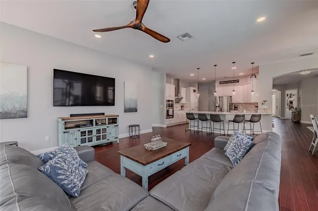 a view of a big house with a big yard and large trees