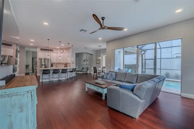 a front view of a house with a garden and swimming pool
