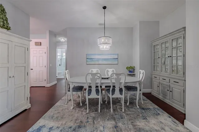 a view of a swimming pool with lawn chairs and a fire pit
