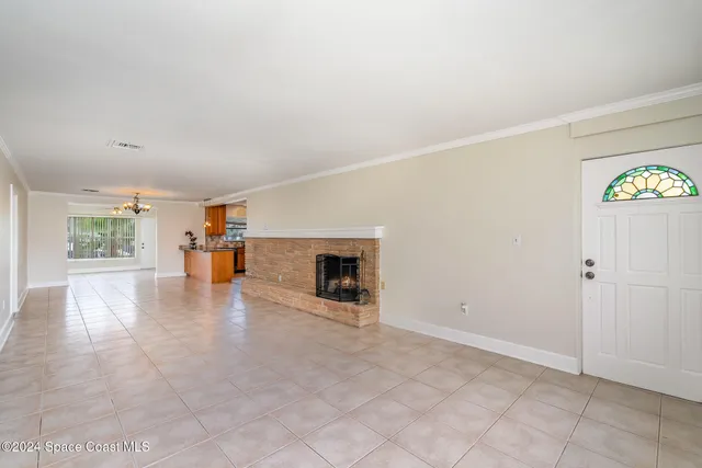 an empty room with fireplace and windows