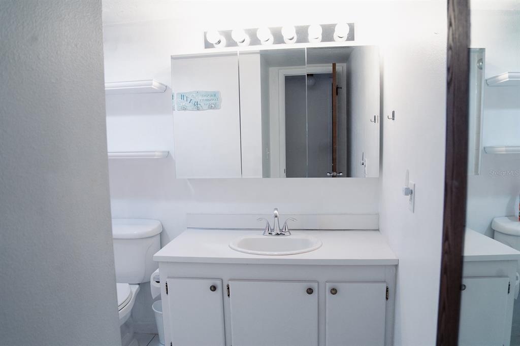 519 Albee Farm Road, Unit 110 Venice, FL 34285 - Photo 16 of 33 a bathroom with a sink a toilet and a mirror