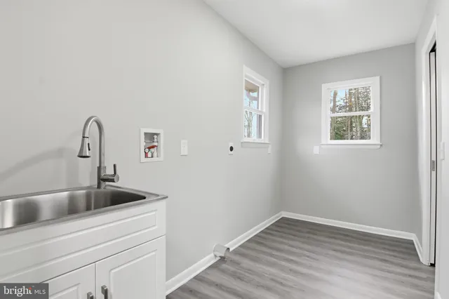 a close view of a sink a faucet and chandelier in a room