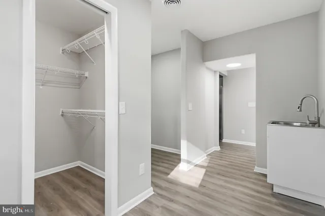 a view of hallway with wooden floor