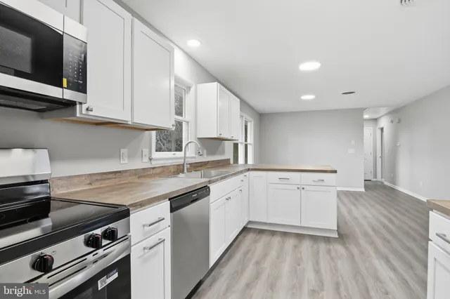 a kitchen with a sink stove and cabinets