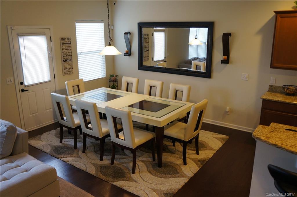 9027 Paddle Oak Road Charlotte, NC 28227 - Photo 3 of 22 a view of a dining room with furniture and wooden floor