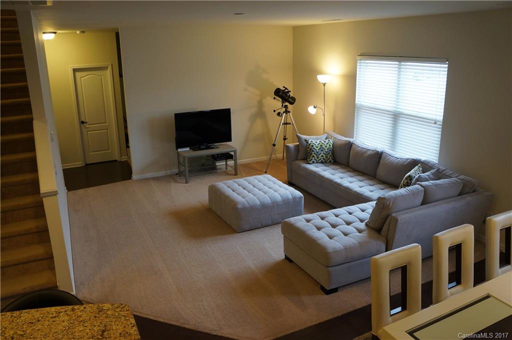 9027 Paddle Oak Road Charlotte, NC 28227 - Photo 4 of 22 a living room with furniture and a flat screen tv