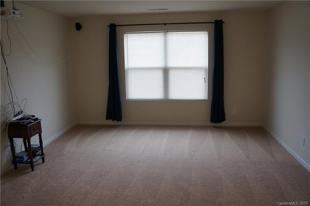 9027 Paddle Oak Road Charlotte, NC 28227 - Photo 7 of 22 an empty room with a window