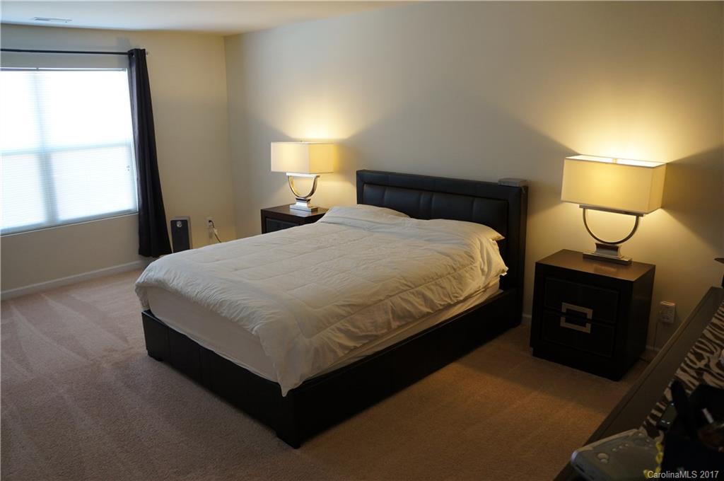 9027 Paddle Oak Road Charlotte, NC 28227 - Photo 8 of 22 a large bed sitting in a bedroom next to a window
