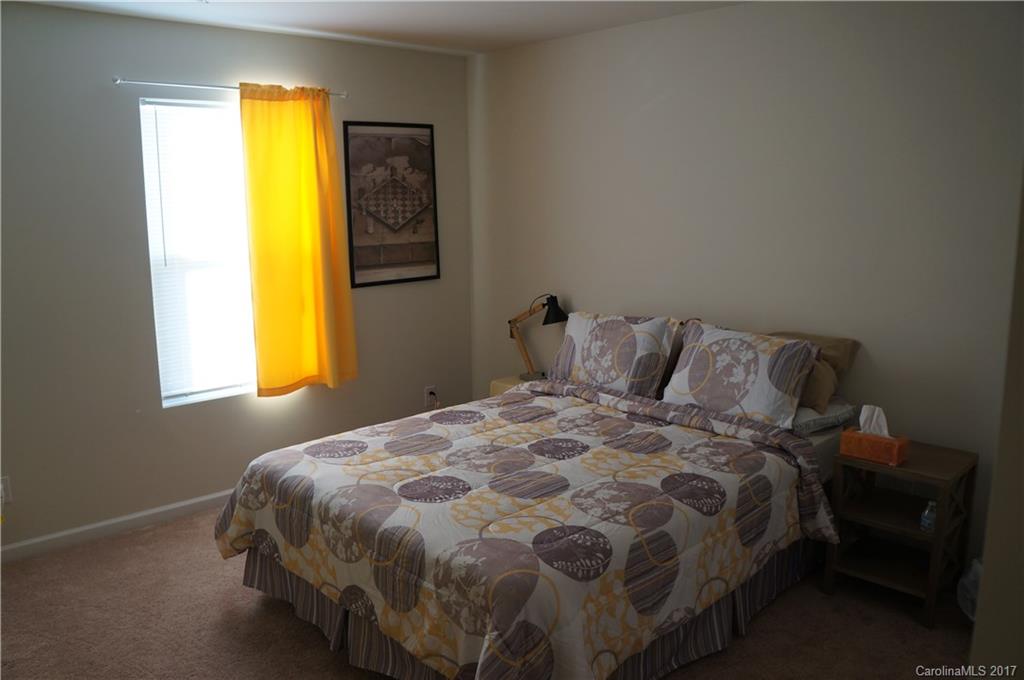 9027 Paddle Oak Road Charlotte, NC 28227 - Photo 10 of 22 a bedroom with a bed and lamps