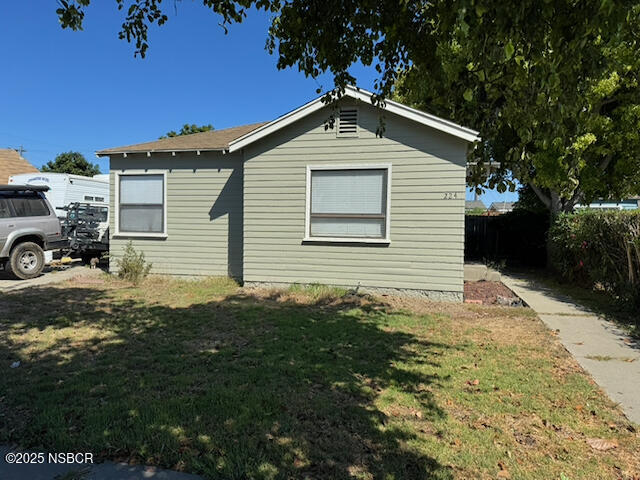 220 North F Street Lompoc, CA 93436 - Photo 5 of 15 a front view of a house with a yard