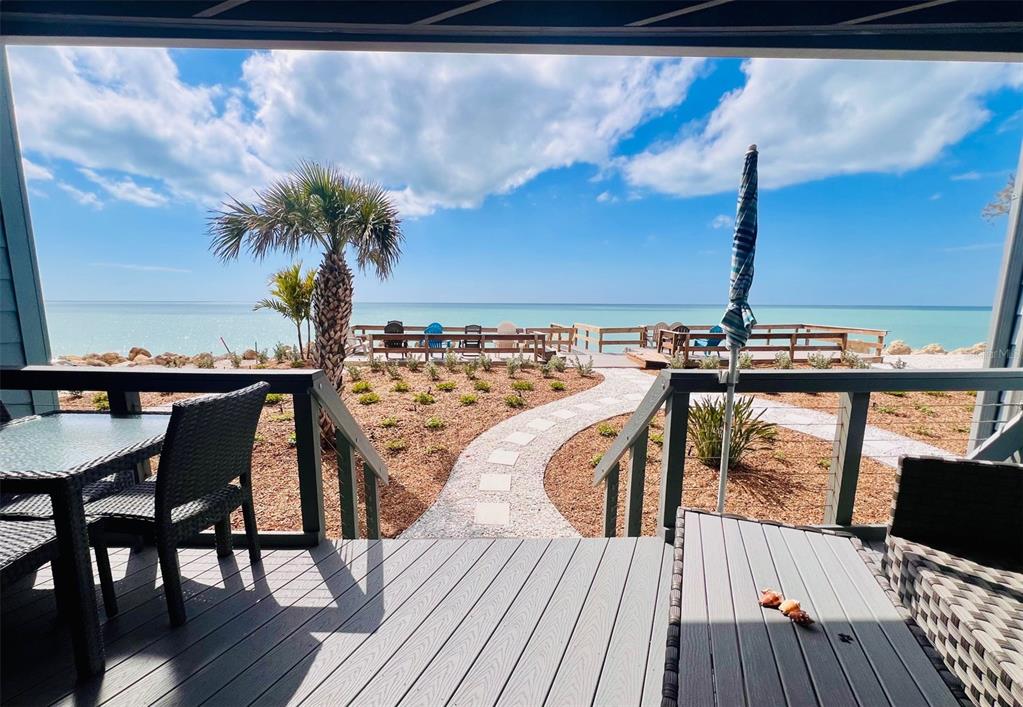 5030 North Beach Road, Unit 3 Englewood, FL 34223 - Photo 13 of 67 a view of a balcony with chairs and wooden floor
