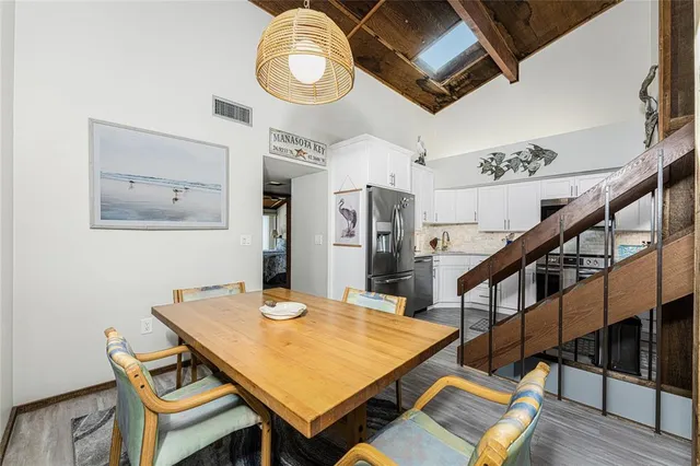 a kitchen with stainless steel appliances a sink a stove and cabinets