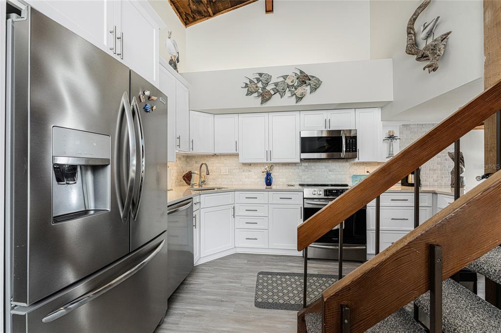 5030 North Beach Road, Unit 3 Englewood, FL 34223 - Photo 21 of 67 a kitchen with stainless steel appliances granite countertop a refrigerator and a stove top oven