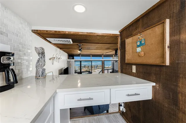 a view of a room with wooden floor and windows