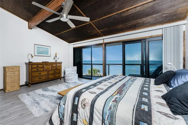 a bedroom with a large bed and a large window