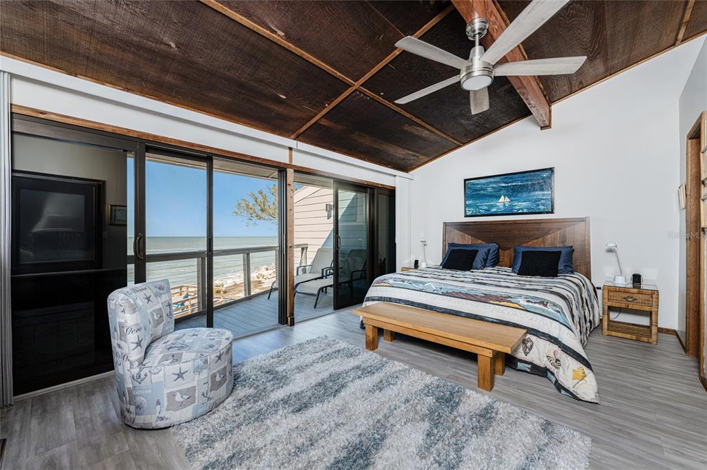 5030 North Beach Road, Unit 3 Englewood, FL 34223 - Photo 31 of 67 a spacious bedroom with a bed and wooden floor