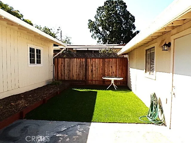 a backyard with a table and chairs