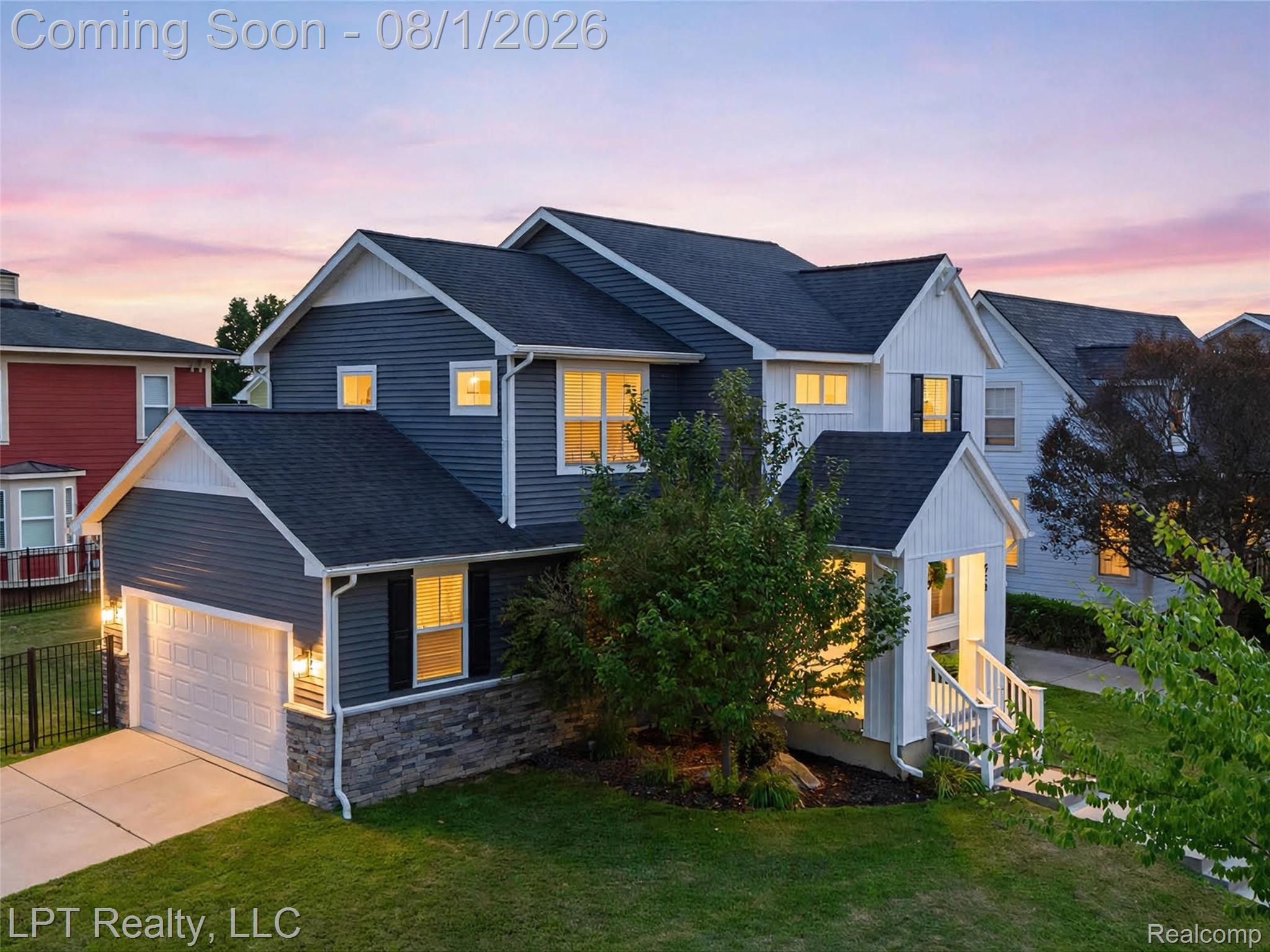 511 York Road Howell, MI 48855 - Photo 2 of 35 Contemporary two-story residence featuring dark siding with white trim, a stone accent foundation, and an attached garage