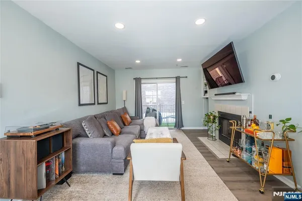 a living room with fireplace furniture and a flat screen tv