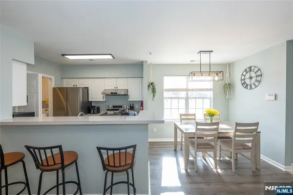 a view of a dining room with furniture and wooden floor