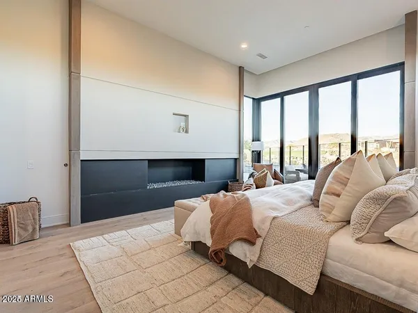 a bedroom with a large bed and a large window