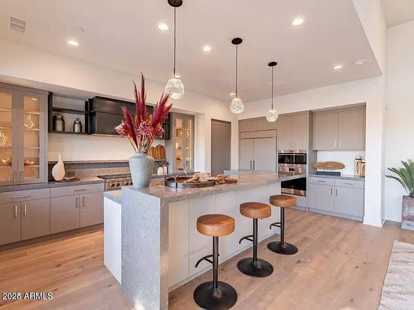 a kitchen with sink refrigerator dining table and chairs