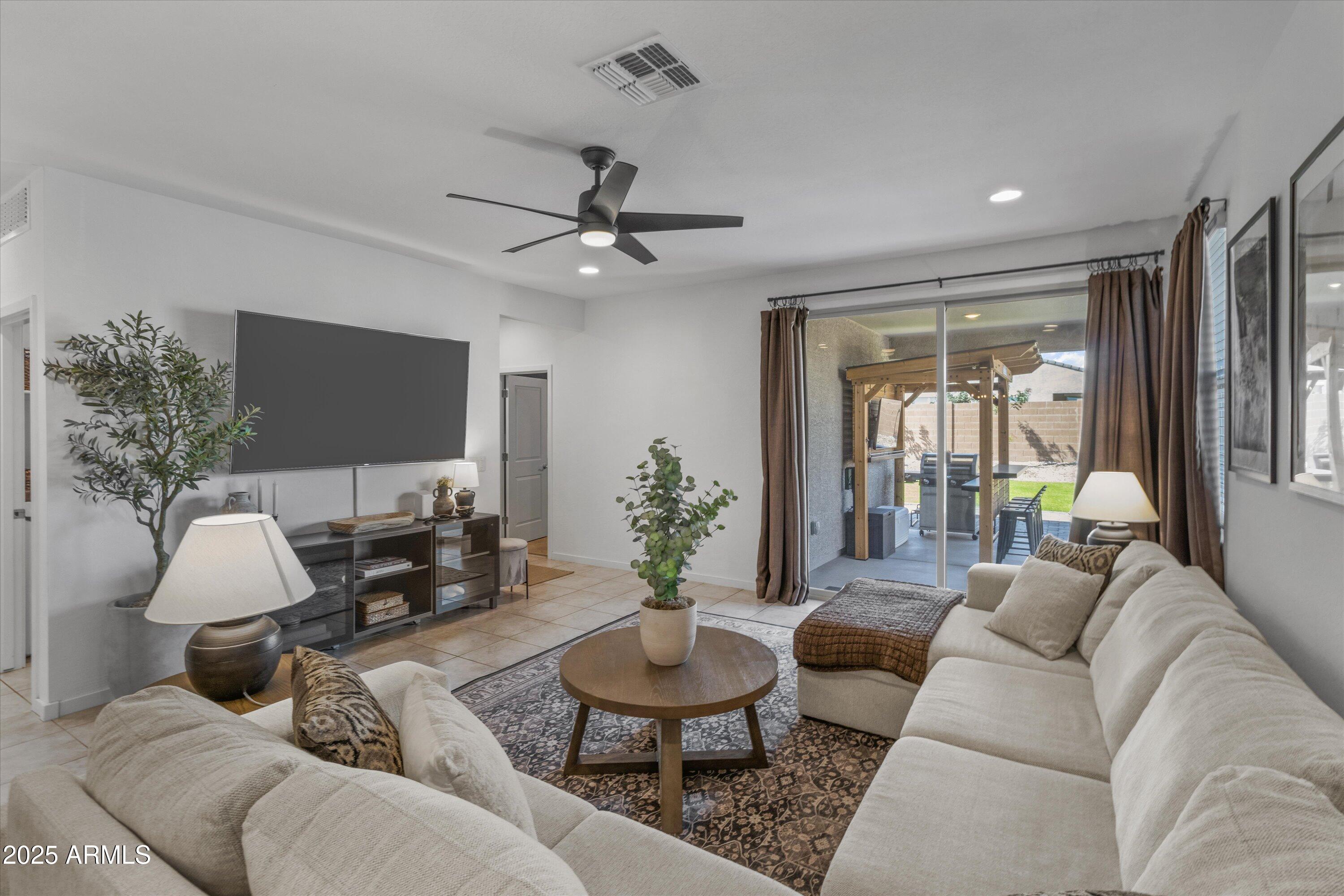 17970 West Pierson Street Goodyear, AZ 85395 - Photo 14 of 66 a living room with furniture and a flat screen tv