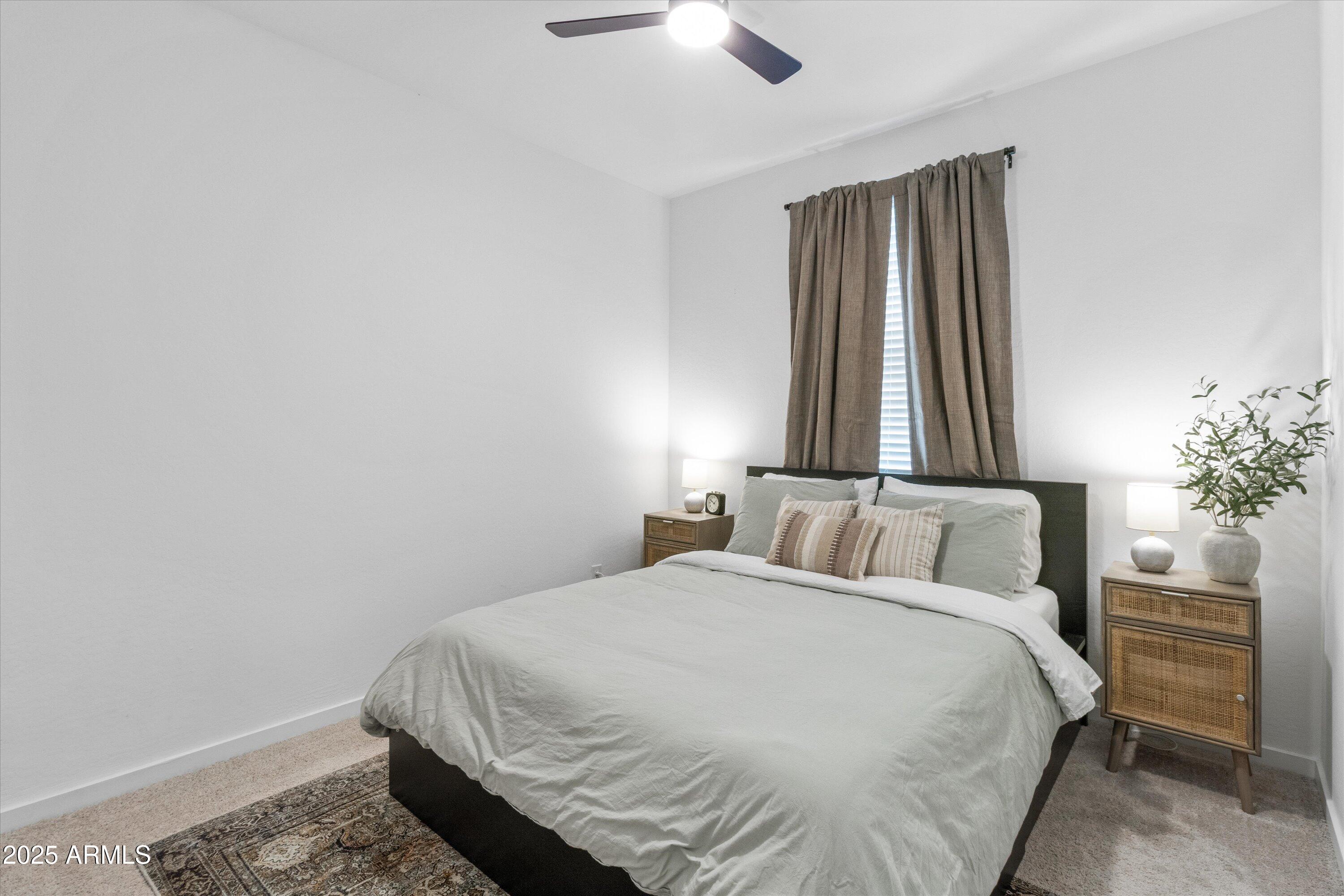 17970 West Pierson Street Goodyear, AZ 85395 - Photo 17 of 66 a bedroom with a bed and a chandelier