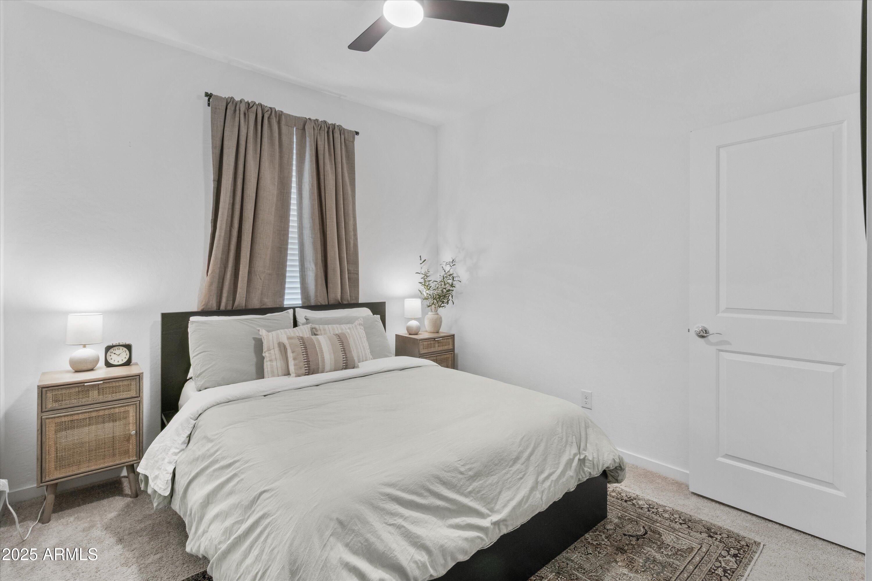 17970 West Pierson Street Goodyear, AZ 85395 - Photo 18 of 66 a bedroom with a bed and a chandelier