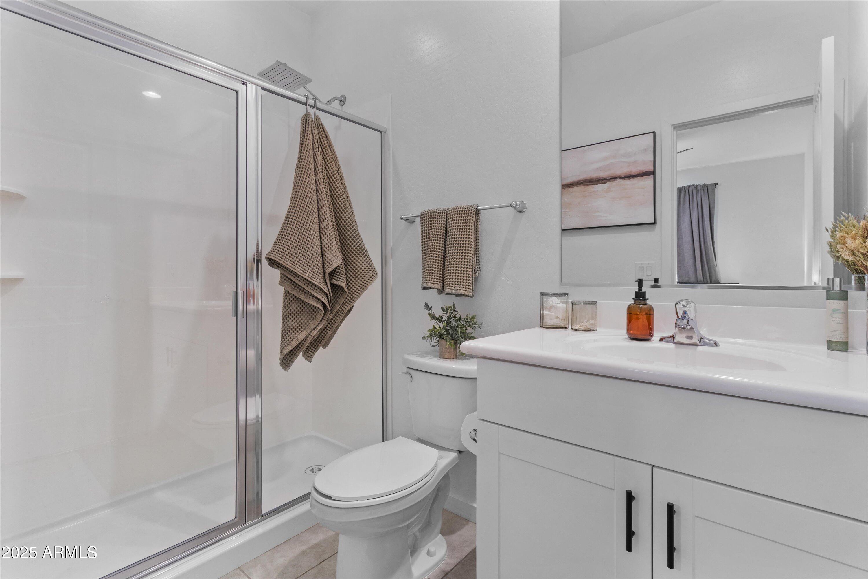 17970 West Pierson Street Goodyear, AZ 85395 - Photo 19 of 66 a bathroom with a sink toilet and shower