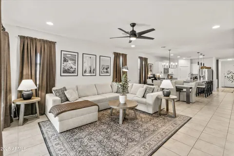 a living room with furniture and a view of kitchen