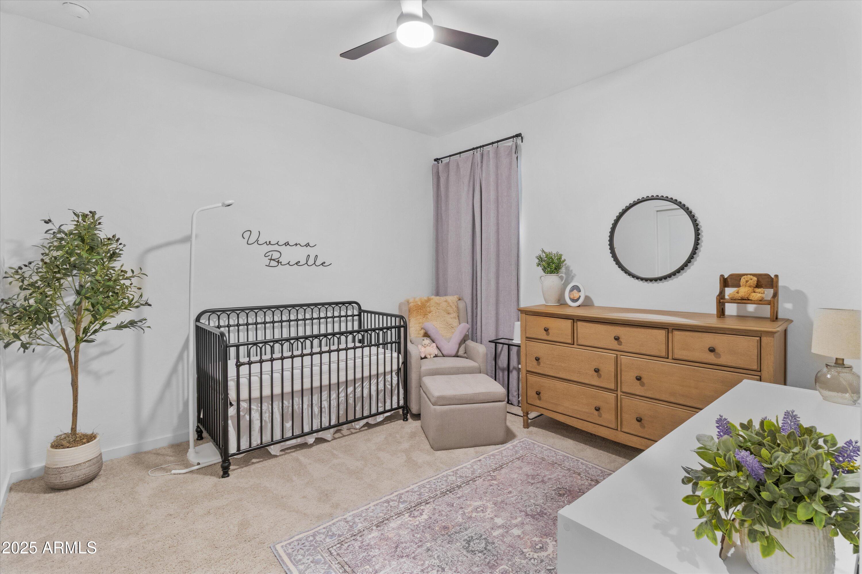 17970 West Pierson Street Goodyear, AZ 85395 - Photo 24 of 66 a bedroom with a bed and a chandelier