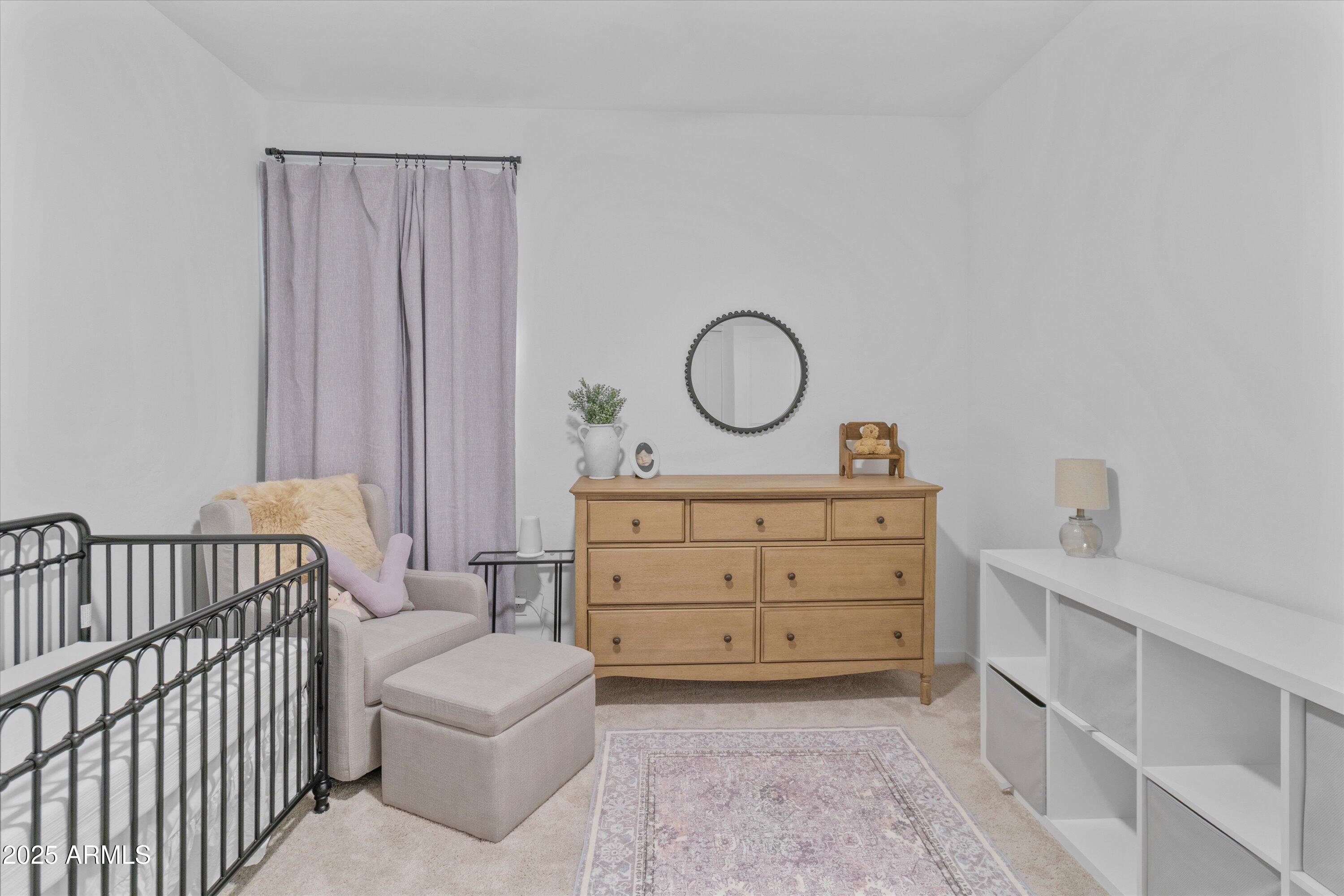 17970 West Pierson Street Goodyear, AZ 85395 - Photo 25 of 66 a living room with a baby crib furniture and a dresser