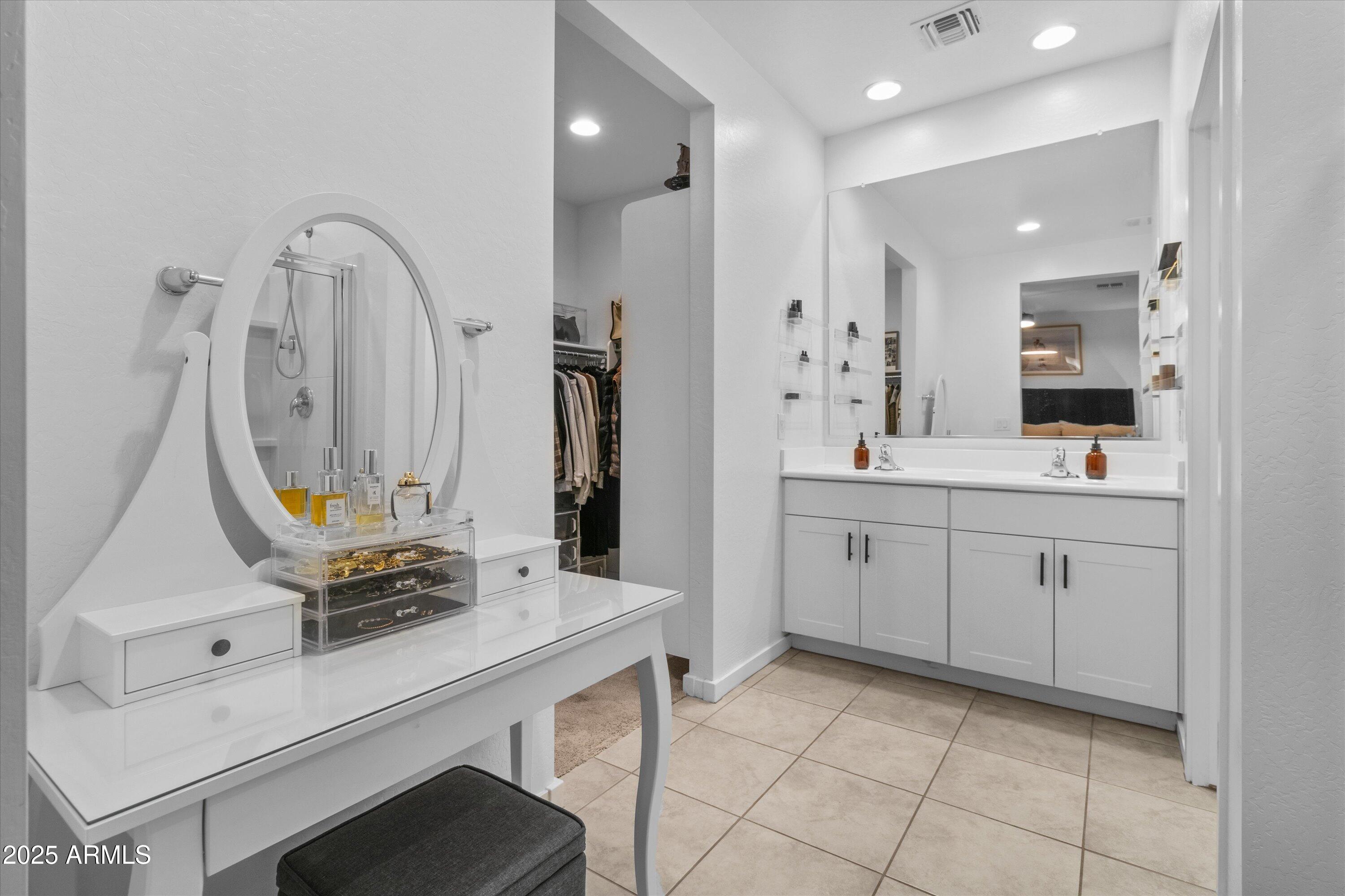 17970 West Pierson Street Goodyear, AZ 85395 - Photo 32 of 66 a bathroom with a sink vanity granite tub shower and a mirror