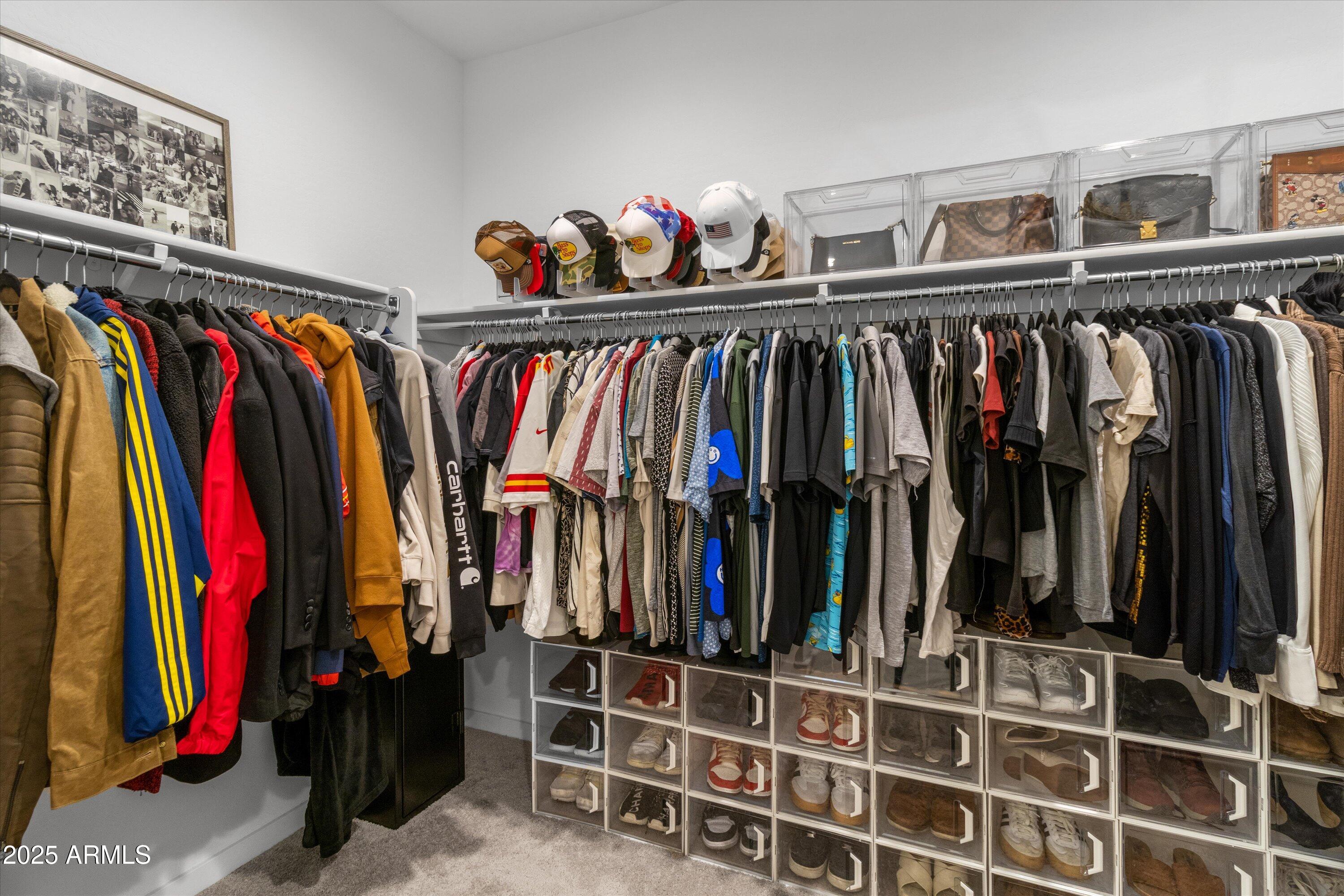17970 West Pierson Street Goodyear, AZ 85395 - Photo 35 of 66 a view of walk in closet with clothes and shoes
