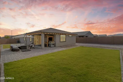 a view of a house with a backyard