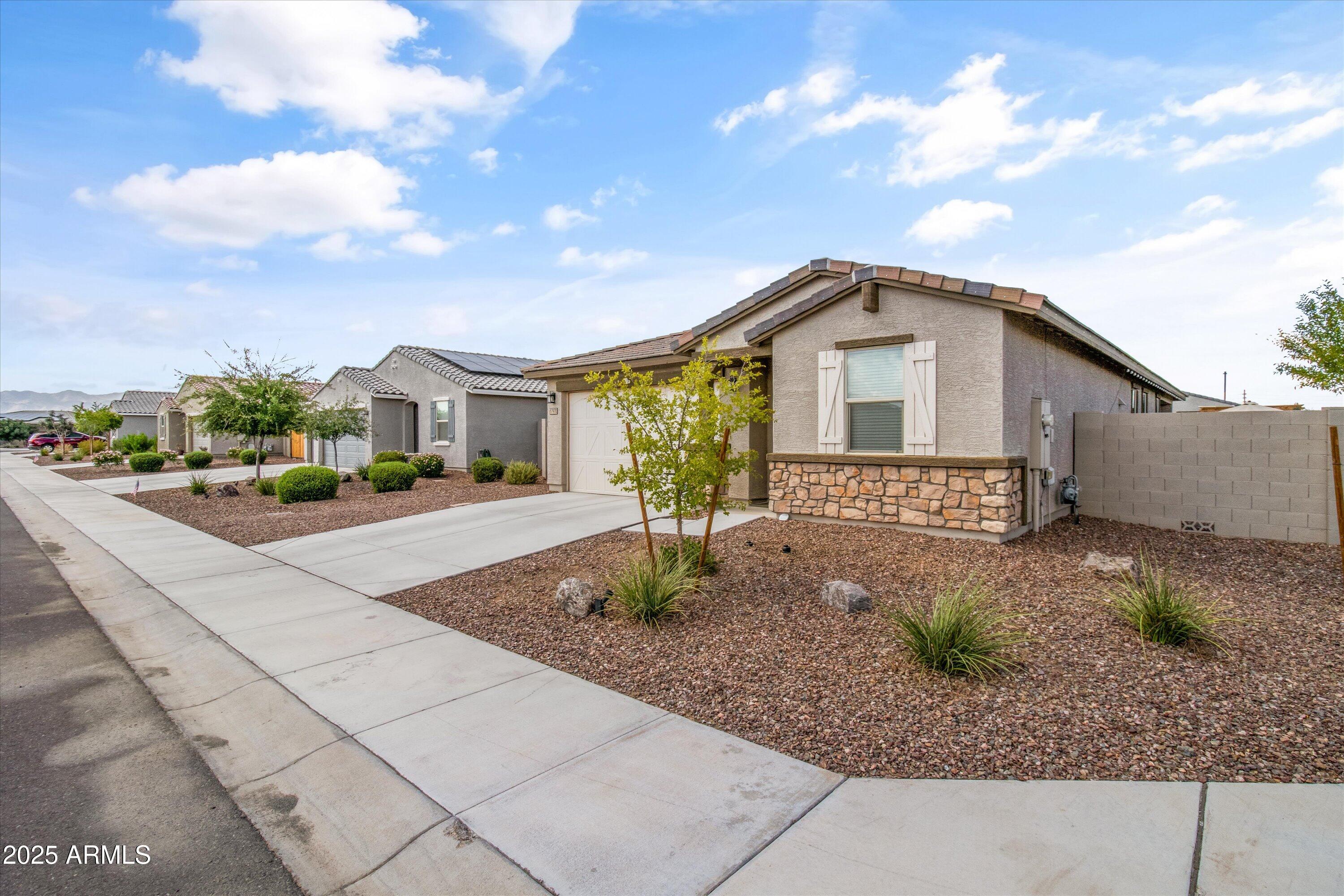 17970 West Pierson Street Goodyear, AZ 85395 - Photo 50 of 66 a front view of a house with garden
