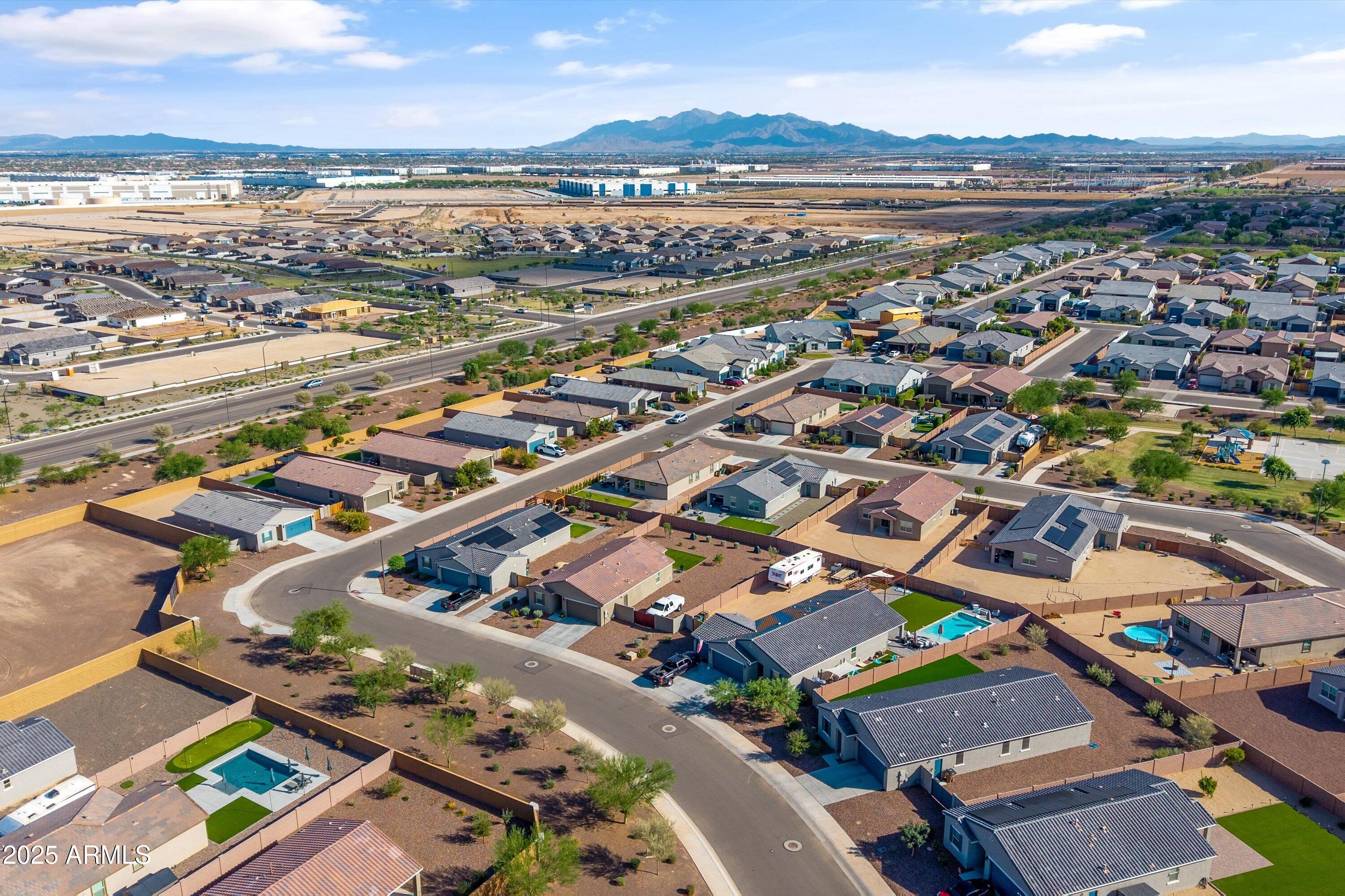 17970 West Pierson Street Goodyear, AZ 85395 - Photo 55 of 66 an aerial view of a city with lots of residential buildings and mountain view in back