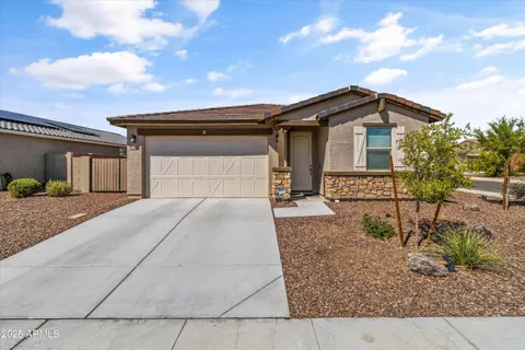 a kitchen with stainless steel appliances kitchen island granite countertop a table chairs stove and white cabinets
