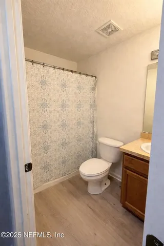 a view of a sign board with a building in the background