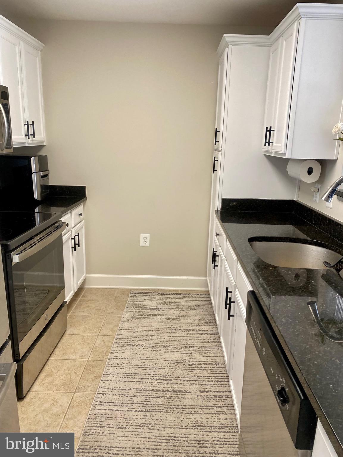 11800 Sunset Hills Road, Unit 1211 Reston, VA 20190 - Photo 23 of 37 WHITE CABINETS AND STAINLESS STEEL APPLIANCES