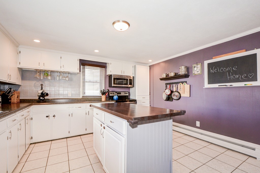 854 Boston Road Billerica, MA 01821 - Photo 14 of 30 a kitchen with granite countertop white cabinets sink and stainless steel appliances