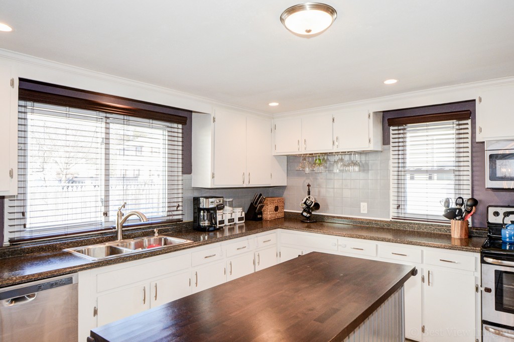 854 Boston Road Billerica, MA 01821 - Photo 16 of 30 a kitchen with a sink a counter top space cabinets stainless steel appliances and a large window