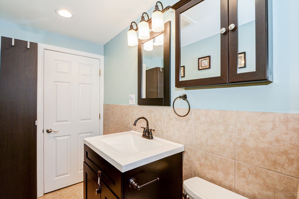 854 Boston Road Billerica, MA 01821 - Photo 17 of 30 a bathroom with a toilet sink and mirror