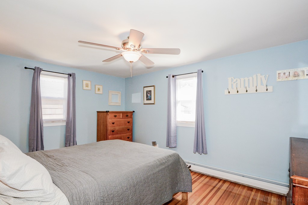 854 Boston Road Billerica, MA 01821 - Photo 19 of 30 a bedroom with a bed and wooden floor