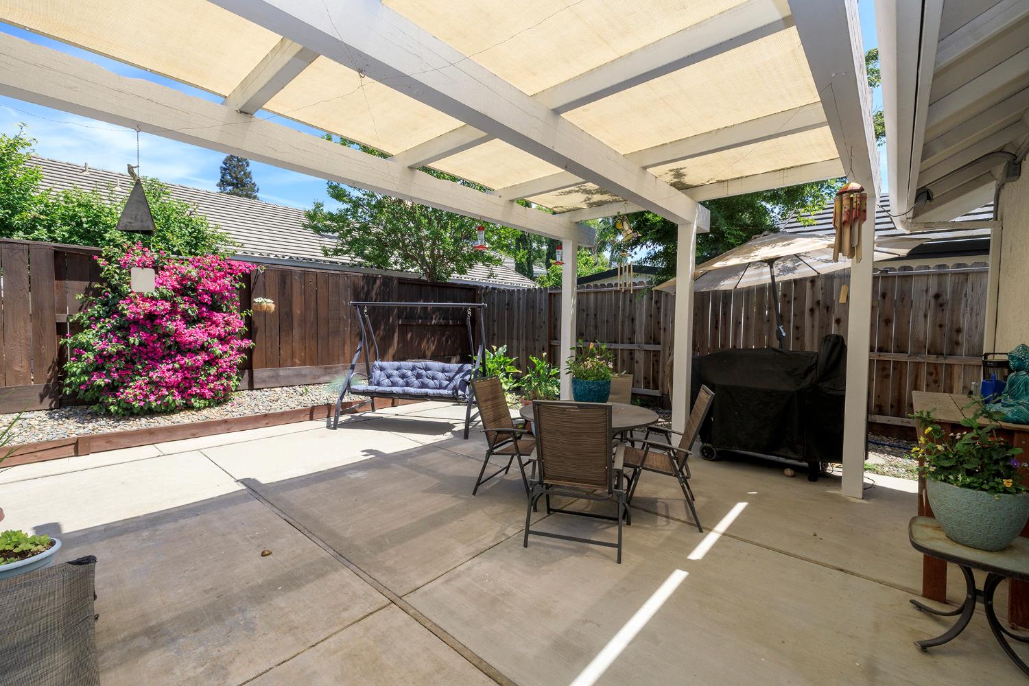 230 Meyenberg Avenue Ripon, CA 95366 - Photo 43 of 52 a view of a patio with table and chairs potted plants