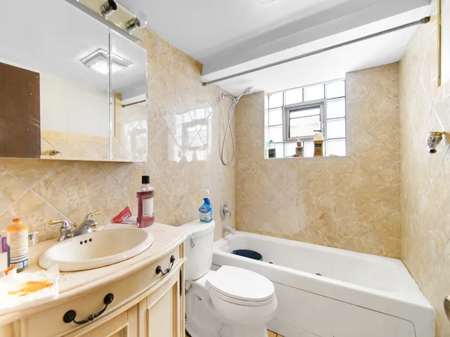 a bathroom with a sink toilet tub and shower