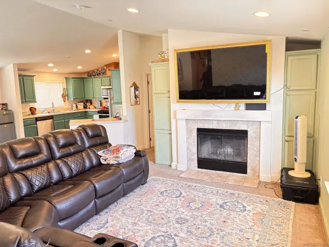 a living room with furniture and kitchen view