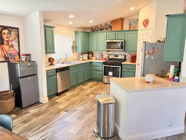 a kitchen with a sink appliances and cabinets