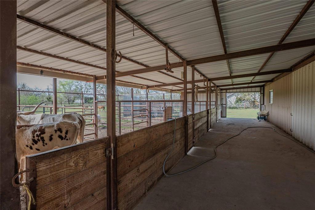 900 Silver Creek Azle Road Azle, TX 76020 - Photo 25 of 27 Barn interior featuring a concrete floor, metal frame construction, and corrugated metal roof